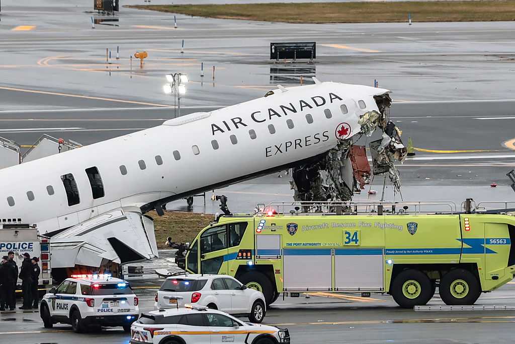 Two pilots killed after jet collides with firetruck at New York's LaGuardia Airport