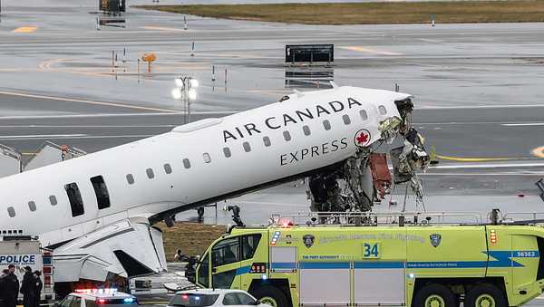 An Air Canada Express CRJ-900 sits on the runway after colliding with a Port Authority fire truck at LaGuardia Airport on March 23, 2026 in New York City.