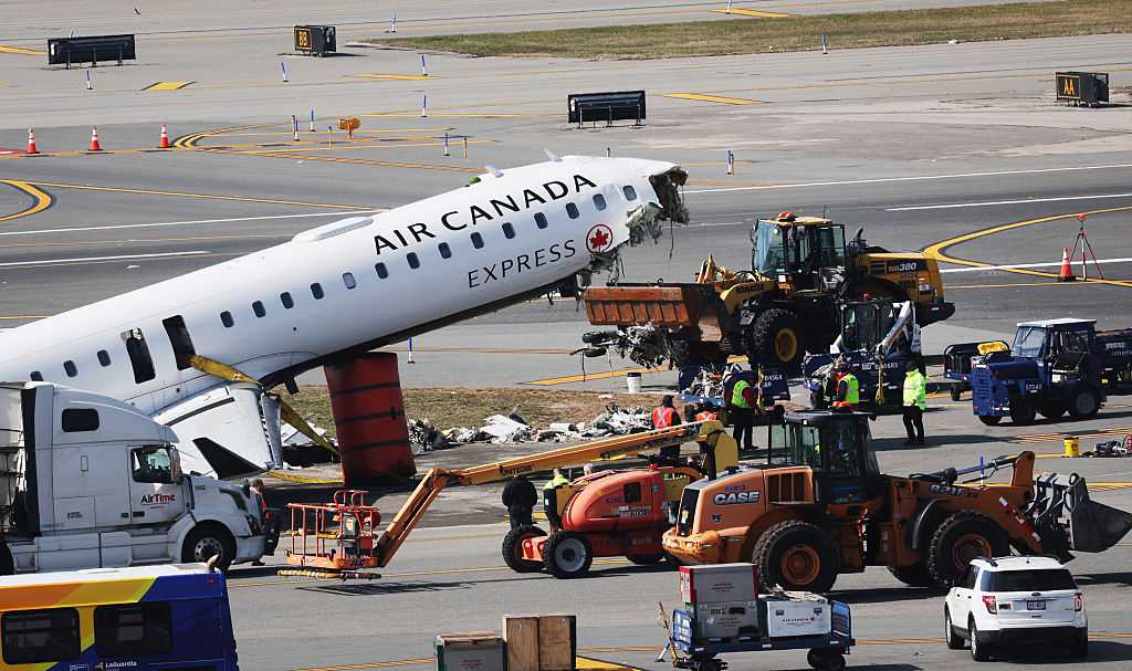 Mangled plane in LaGuardia crash is towed from runway as most injured passengers leave hospital