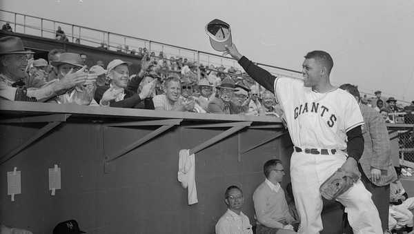 (Original Caption) New York Giant's centerfielder Willie Mays waves to the crowd form the dugout after he arrived for Spring training at Phoenix, as shown here. Willie flew from his Army camp in Virginia, released after serving almost two years in the Army.