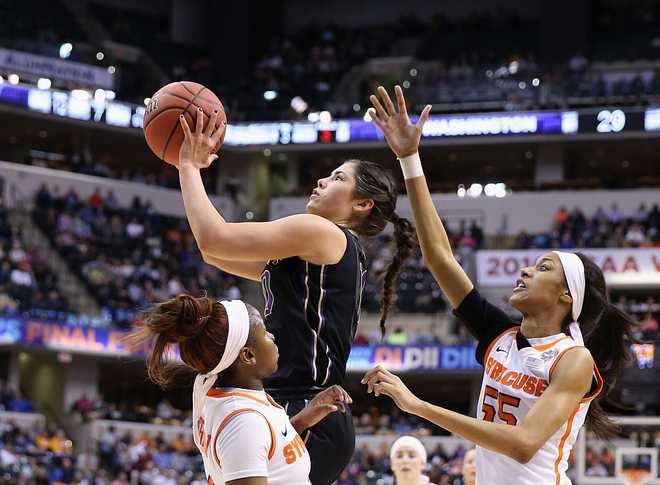 INDIANAPOLIS,&#x20;IN&#x20;-&#x20;APRIL&#x20;03&#x3A;&#x20;&#x20;Kelsey&#x20;Plum&#x20;&#x23;10&#x20;of&#x20;the&#x20;Washington&#x20;Huskies&#x20;shoots&#x20;against&#x20;Julia&#x20;Chandler&#x20;&#x23;3&#x20;and&#x20;Bria&#x20;Day&#x20;&#x23;55&#x20;of&#x20;the&#x20;Syracuse&#x20;Orange&#x20;in&#x20;the&#x20;first&#x20;quarter&#x20;during&#x20;the&#x20;semifinals&#x20;of&#x20;the&#x20;2016&#x20;NCAA&#x20;Women&amp;apos&#x3B;s&#x20;Final&#x20;Four&#x20;Basketball&#x20;Championship&#x20;at&#x20;Bankers&#x20;Life&#x20;Fieldhouse&#x20;on&#x20;April&#x20;3,&#x20;2016&#x20;in&#x20;Indianapolis,&#x20;Indiana.&#x20;&#x20;&#x28;Photo&#x20;by&#x20;Andy&#x20;Lyons&#x2F;Getty&#x20;Images&#x29;
