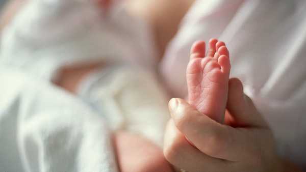 Stock photo of newborn's tiny foot