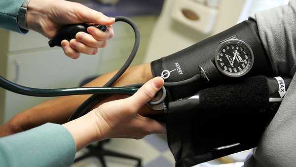 DORCHESTER, MA - APRIL 11:  Dr. Elizabeth Maziarka reads a blood pressure gauge during an examination of patient June Mendez at the Codman Square Health Center April 11, 2006 in Dorchester, Massachusetts. Massachusetts Governor Mitt Romney is scheduled to sign a health care reform bill April 12 that would make it the first state in the nation to require all its citizens have some form of health insurance.  (Photo by Joe Raedle/Getty Images)