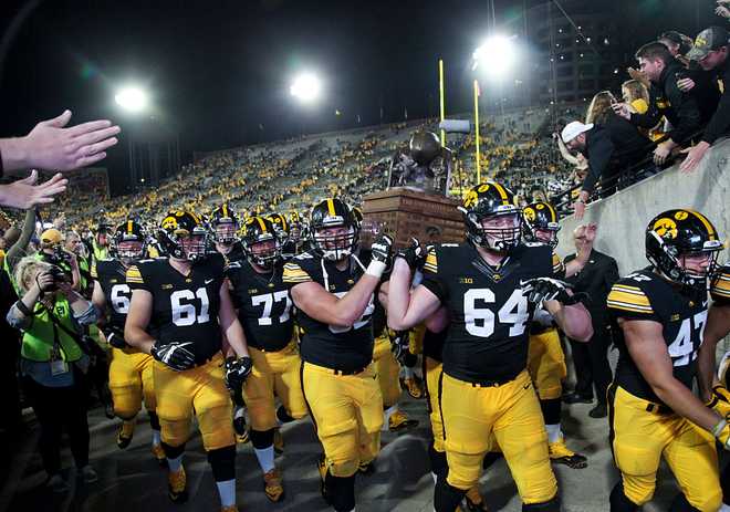 IOWA&#x20;CITY,&#x20;IOWA-&#x20;SEPTEMBER&#x20;10&#x3A;&#x20;&#x20;Offensive&#x20;linemen&#x20;Cole&#x20;Croston&#x20;&#x23;64&#x20;and&#x20;Boone&#x20;Myers&#x20;&#x23;52&#x20;of&#x20;the&#x20;Iowa&#x20;Hawkeyes&#x20;carry&#x20;the&#x20;Cy-Hawk&#x20;trophy&#x20;off&#x20;the&#x20;field&#x20;after&#x20;defeating&#x20;the&#x20;Iowa&#x20;State&#x20;Cyclones&#x20;on&#x20;September&#x20;10,&#x20;2016&#x20;at&#x20;Kinnick&#x20;Stadium&#x20;in&#x20;Iowa&#x20;City,&#x20;Iowa.&#x20;&#x20;&#x28;Photo&#x20;by&#x20;Matthew&#x20;Holst&#x2F;Getty&#x20;Images&#x29;