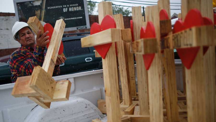 Greg Zanis unloads wooden crosses from the back of his truck at a planned prayer vigil and rally against violence in Chicago, Illinois on May 20, 2017.