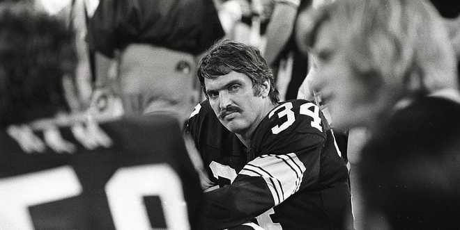 Linebacker Andy Russell #34 of the Pittsburgh Steelers sits on the sideline during a preseason game against the New York Jets at Three Rivers.  Stadium on September 4, 1976 in Pittsburgh, Pennsylvania.