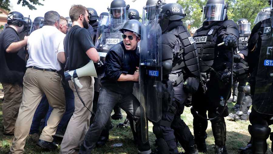 CHARLOTTESVILLE, VA - AUGUST 12, 2017: White nationalists, neo-Nazis and members of the 'alt-right' clash with police as they are forced out of Emancipation Park after the 'Unite the Right' rally was declared an unlawful gathering August 12, 2017, in Charlottesville, Virginia.