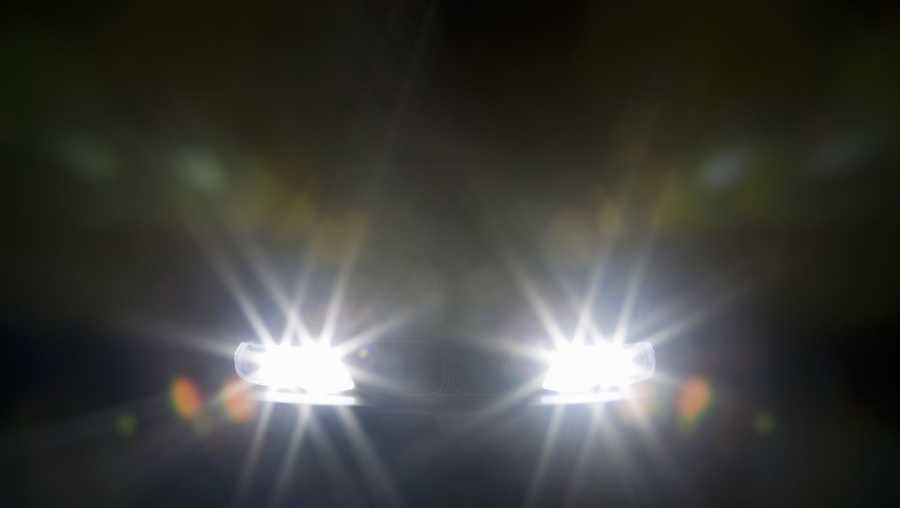 a car headlights illuminated at night