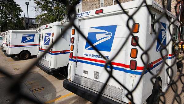 CHICAGO - AUGUST 25:  United States Postal Service trucks sit outside the Roberto Clemente Post Office August 25, 2009 in Chicago, Illinois. The Postal Service announced it would offer $15,000 for buyouts of up to 30,000 employees eligible for retirement, early retirement, or those in select positions.  (Photo by Scott Olson/Getty Images)