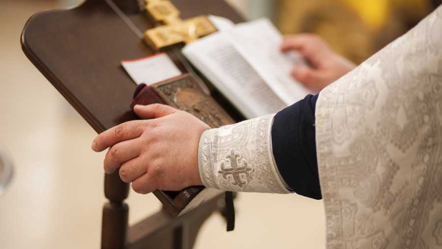 hands of priest on pulpit