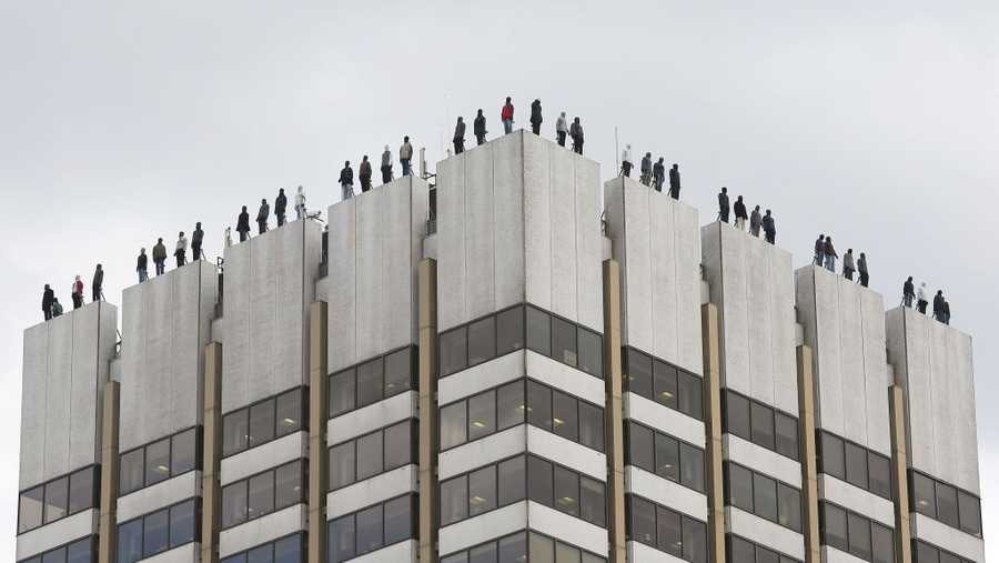The sculptures of 84 men, made by American artist Mark Jenkins and his collaborator, Sandra Fernandez, part of Project 84, a campaign to raise awareness of the fact that 84 men take their own lives every week in the UK, ontop of London Television Centre after the installation was unveiled.