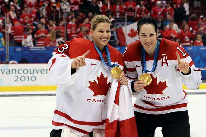 VANCOUVER,&#x20;BC&#x20;-&#x20;FEBRUARY&#x20;25&#x3A;&#x20;&#x20;&#x28;L-R&#x29;&#x20;Kim&#x20;St-Pierre&#x20;&#x23;33&#x20;and&#x20;Caroline&#x20;Ouellette&#x20;&#x23;13&#x20;of&#x20;Canada&#x20;pose&#x20;with&#x20;the&#x20;gold&#x20;medals&#x20;won&#x20;during&#x20;the&#x20;ice&#x20;hockey&#x20;women&amp;apos&#x3B;s&#x20;gold&#x20;medal&#x20;game&#x20;between&#x20;Canada&#x20;and&#x20;USA&#x20;on&#x20;day&#x20;14&#x20;of&#x20;the&#x20;Vancouver&#x20;2010&#x20;Winter&#x20;Olympics&#x20;at&#x20;Canada&#x20;Hockey&#x20;Place&#x20;on&#x20;February&#x20;25,&#x20;2010&#x20;in&#x20;Vancouver,&#x20;Canada.&#x20;&#x20;&#x28;Photo&#x20;by&#x20;Bruce&#x20;Bennett&#x2F;Getty&#x20;Images&#x29;