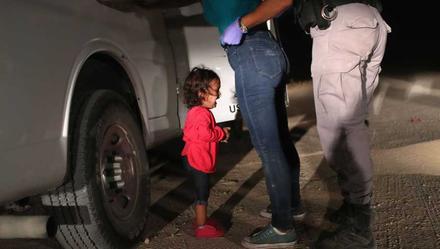 A two-year-old Honduran asylum seeker cries as her mother is searched and detained near the U.S.-Mexico border on June 12, 2018 in McAllen, Texas. The asylum seekers had rafted across the Rio Grande from Mexico and were detained by U.S. Border Patrol agents before being sent to a processing center for possible separation. 