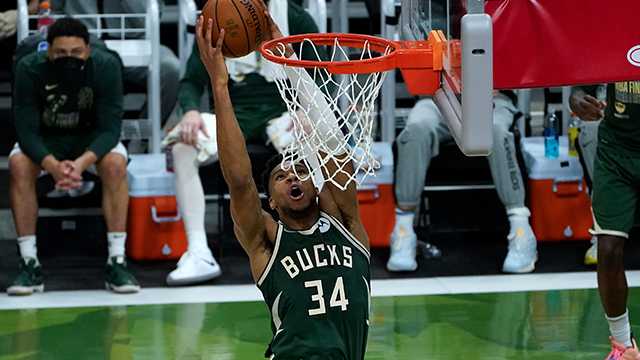 Milwaukee Bucks forward Giannis Antetokounmpo (34) dunks against the Phoenix Suns during the second half of Game 3 of basketball's NBA Finals in Milwaukee, Sunday, July 11, 2021.