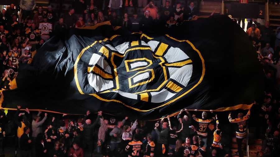 Fans pass a giant flag around TD Garden before Game 3 of an NHL hockey Stanley Cup first-round playoff series between the Boston Bruins and the Carolina Hurricanes, Friday, May 6, 2022, in Boston.