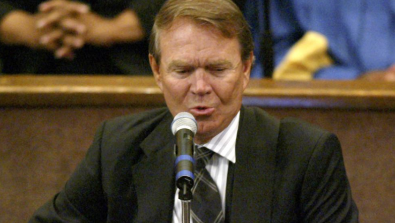 Glen Campbell performs during the funeral of Ray Charles, Los Angeles, California, photo on black