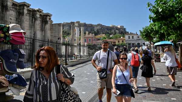 Tourists and locals walk in a touristic area of Athens on June 1. The CDC will no longer maintain a country-by-country list of travel advisories related to Covid-19.