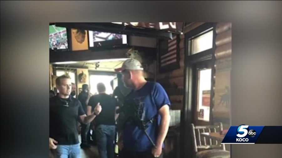Police have arrested a self-proclaimed "Second Amendment auditor" who was pictured bringing a rifle into a Twin Peaks restaurant in Oklahoma City.