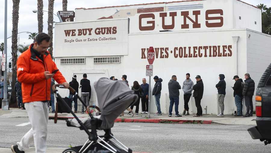 People stand in line outside the Martin B. Retting, Inc. guns store on March 15, 2020 in Culver City, California.