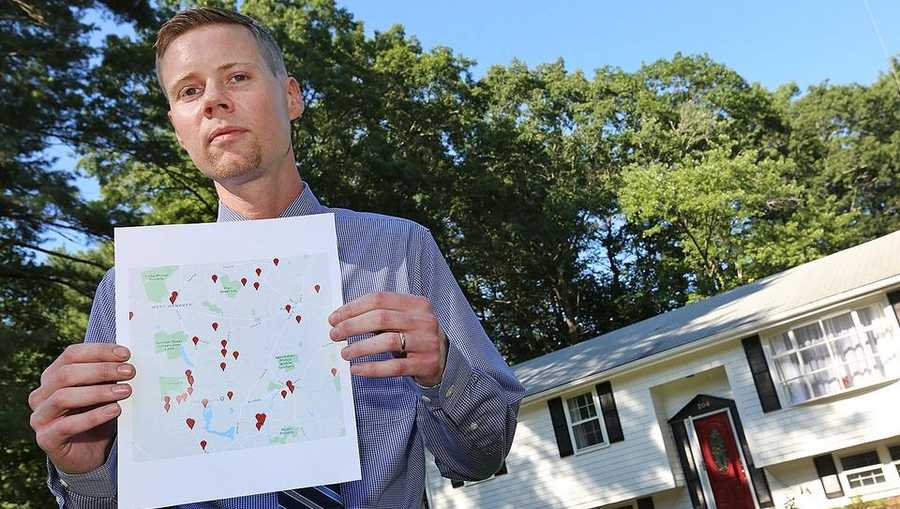Nick Squires, of Hanson, with a map of cancer patients in his old neighborhood of West Hanover on Aug. 19, 2019. Squires grew up next to the former fireworks and munitions manufacturing plant and says the incidence of brain cancer among neighborhood residents in high. (Greg Derr, The Patriot Ledger)