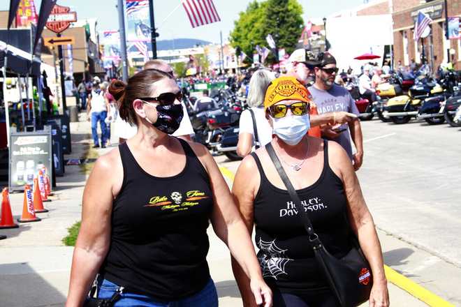 Thousands of bikers rode through the streets for the opening day of the 80th annual Sturgis Motorcycle rally Friday, Aug. 7, 2020, in Sturgis, S.D. Among the crowds of people in downtown Sturgis, a handful wore face masks to prevent the spread of COVID-19.