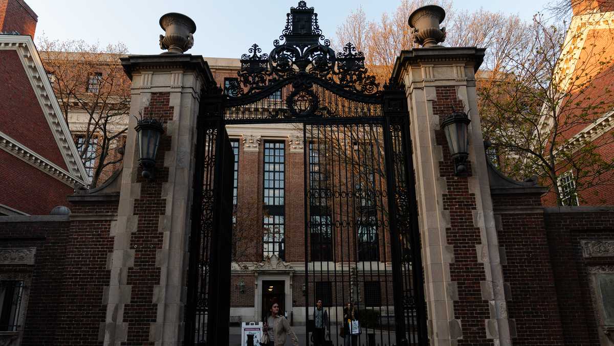 Harvard campus under a cloudy sky, symbolizing frozen funding