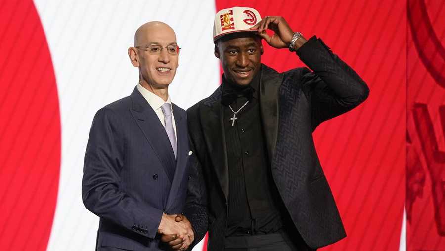 A.J. Griffin tips his cap alongside NBA Commissioner Adam Silver after being selected 16th overall by the Atlanta Hawks in the NBA basketball draft, Thursday, June 23, 2022, in New York. (AP Photo/John Minchillo