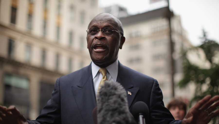 Former 2012 Republican presidential candidate Herman Cain speaks to the media outside of Trump Towers on October 3, 2011 in New York City.