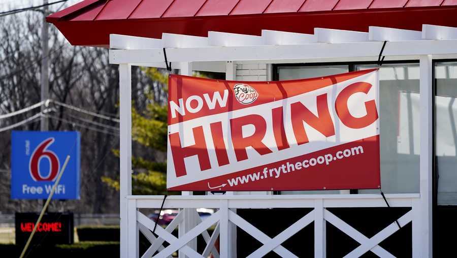 A hiring sign shows outside of restaurant in Prospect Heights, Ill., Sunday, March 21, 2021.
