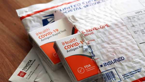 SAN ANSELMO, CALIFORNIA - FEBRUARY 04: In this photo illustration, free iHealth COVID-19 antigen rapid tests from the federal government sit on a U.S. Postal Service envelope after being delivered on February 04, 2022 in San Anselmo, California.