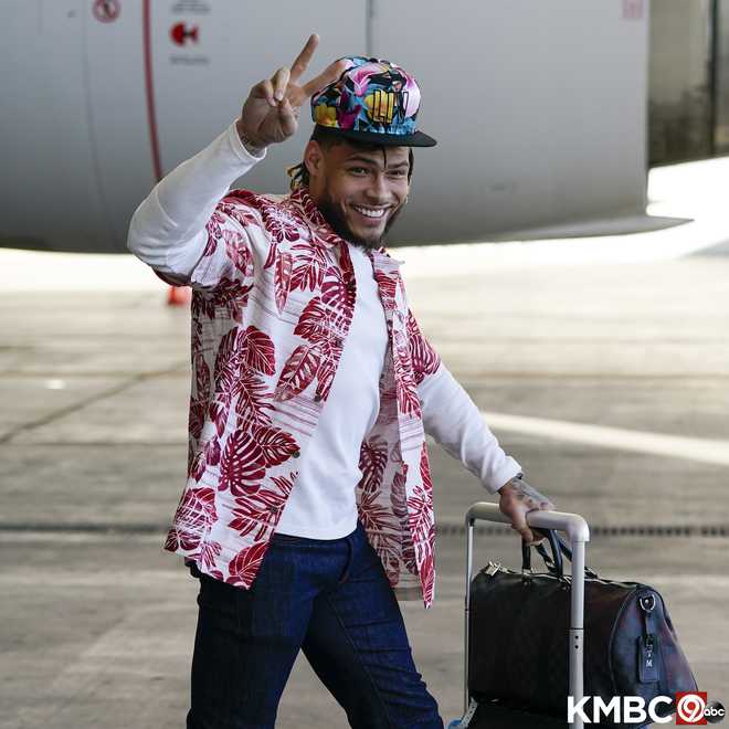 Chiefs players wearing red Hawaiian shirts on Flight to Miami