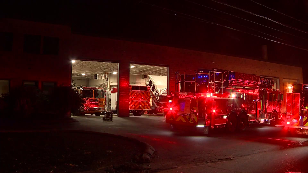 Vehicle inside Hopkinton company with fire trucks parked inside catches fire