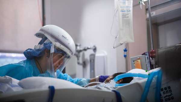 Registered nurse Yeni Sandoval wears personal protective equipment (PPE) while she cares for a COVID-19 patient in the Intensive Care Unit (ICU) at Providence Cedars-Sinai Tarzana Medical Center in Tarzana, California, on Jan. 3, 2021.