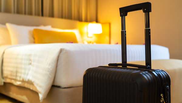 Suitcase delivered standing in hotel room. concept of Hotel service and travel