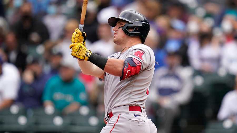 Boston Red Sox's Hunter Renfroe watches the path of his solo home run against the Seattle Mariners in the first inning of a baseball game Wednesday, Sept. 15, 2021, in Seattle. (AP Photo)
