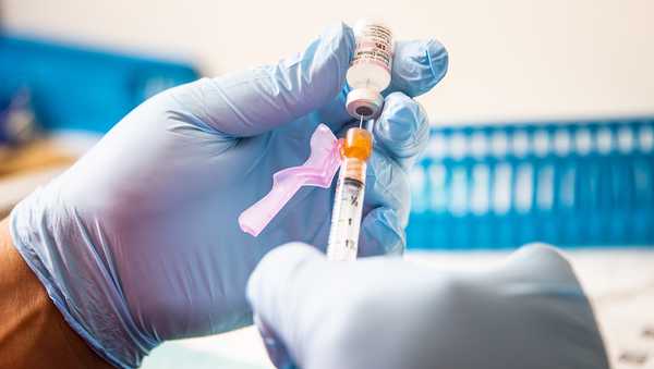 A healthcare worker prepares a dose of the Pfizer-BioNTech Covid-19 vaccine at Boston Medical Center in Boston, Massachusetts, U.S., on Thursday, June 17, 2021.