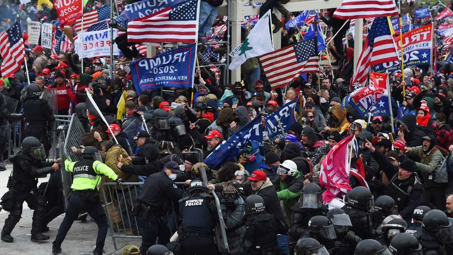 Trump supporters clash with police and security forces as they push barricades to storm the U.S. Capitol in Washington D.C on Jan. 6, 2021. Demonstrators breeched security and entered the Capitol as Congress debated the a 2020 presidential election Electoral Vote certification. (Photo by ROBERTO SCHMIDT/AFP via Getty Images)