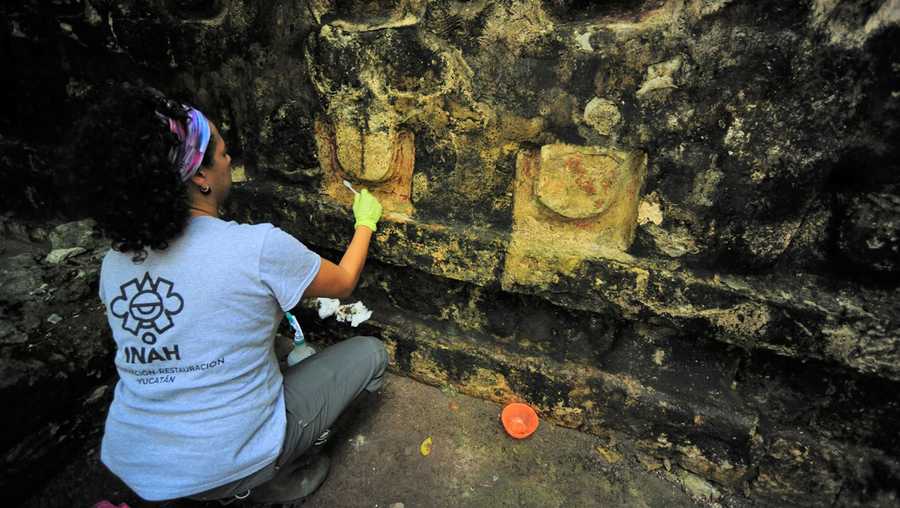 An archeologist works cleaning the stucco of the Temple of the U, located in the archaelogy area of Kuluba, in Tizimin, Yucatan state, Mexico in this handout photograph released to Reuters by the National Institute of Anthropology and History on December 24, 2019.