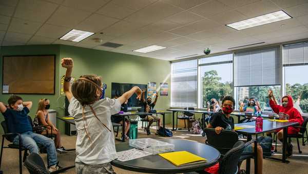 HOUSTON, TEXAS - AUGUST 23: Children participate in an activity in class at the Xavier Academy on August 23, 2021 in Houston, Texas. In-person classroom sessions are resuming and schools around Houston are requiring mask mandates, keeping in accordance with CDC guidelines. Harris County Judge Lina Hidalgo has gone against Gov. Greg Abbott's statewide ban on mask mandates and has issued an order that requires face coverings to be worn in schools. All staff and faculty at Xavier Academy have been vaccinated and 90% of students in attendance have also been vaccinated. (Photo by Brandon Bell/Getty Images)