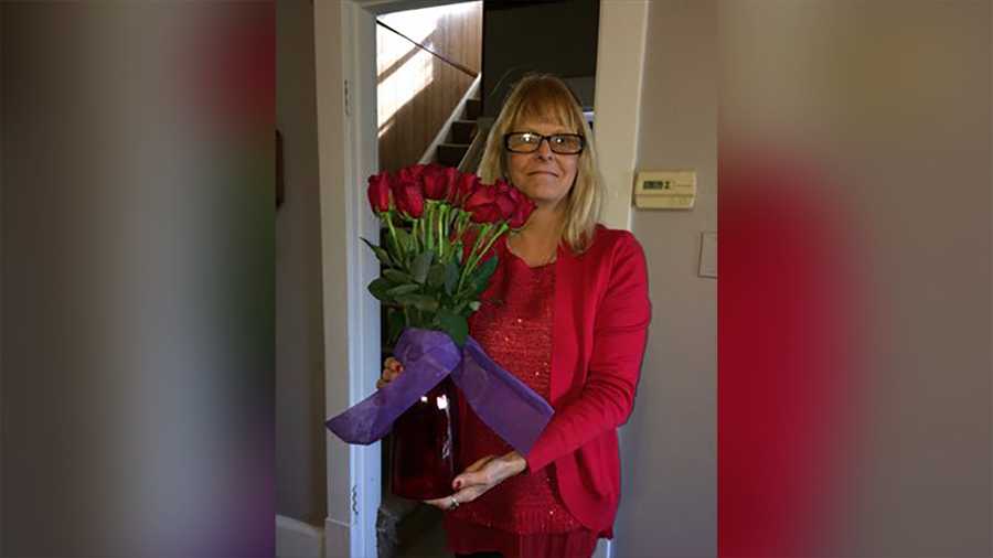 Tracey holds Rich's flower arrangement from 2016.
