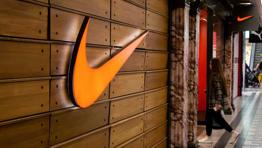 MOSCOW, RUSSIA - 2022/05/30: A woman walks into a Nike boutique in a shopping mall in Moscow. The American sports company is set to stop business in Russia after declining to renew the brand's agreements with authorized resellers within the country.