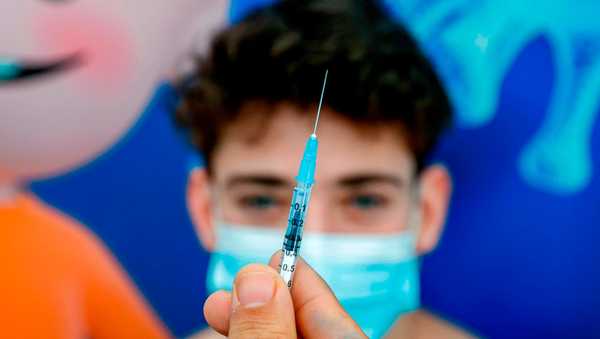 Michael, a 16-year-old teenager, receives a dose of the Pfizer-BioNtech COVID-19 coronavirus vaccine at Clalit Health Services, in Israel's Mediterranean coastal city of Tel Aviv on January 23, 2021.