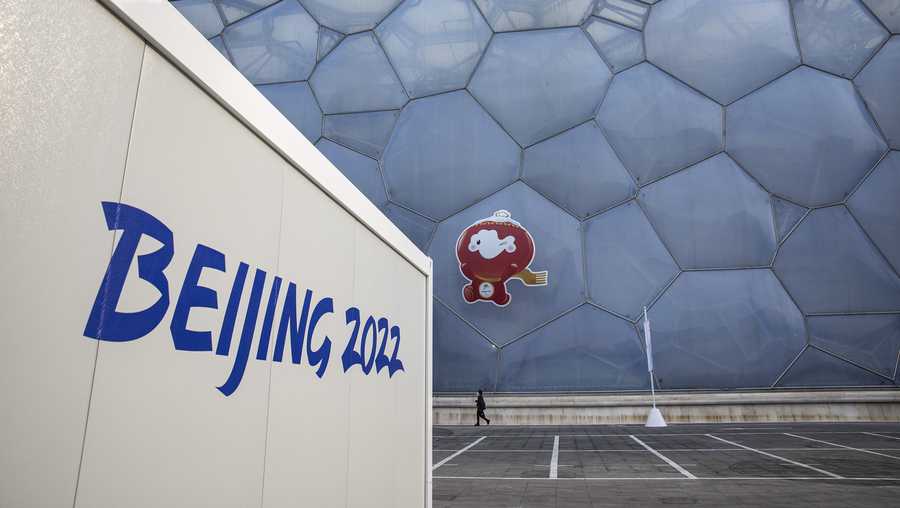 BEIJING, CHINA - FEBRUARY 28:  The peoples walks in front of A general view of National Aquatics Centre on February 28, 2022 in Beijing, China. (Photo by Wang He/Getty Images for International Paralympic Committee)