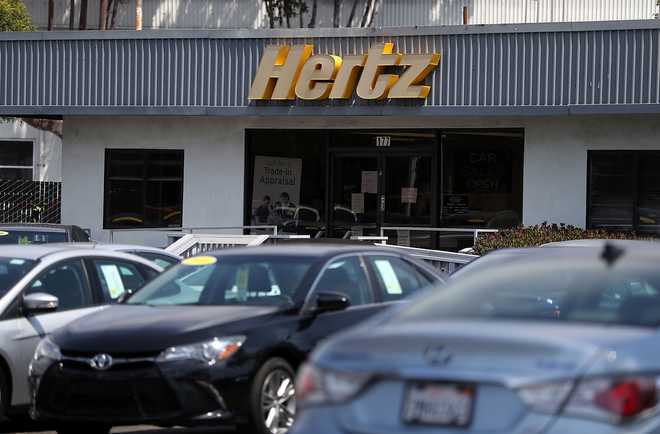 SOUTH&#x20;SAN&#x20;FRANCISCO,&#x20;CA&#x20;-&#x20;AUGUST&#x20;08&#x3A;&#x20;&#x20;A&#x20;sign&#x20;is&#x20;posted&#x20;in&#x20;front&#x20;of&#x20;a&#x20;Hertz&#x20;car&#x20;sales&#x20;and&#x20;rental&#x20;car&#x20;office&#x20;on&#x20;August&#x20;8,&#x20;2017&#x20;in&#x20;South&#x20;San&#x20;Francisco,&#x20;California.&#x20;&#x20;Rental&#x20;car&#x20;companies&#x20;are&#x20;seeing&#x20;a&#x20;drop&#x20;in&#x20;earnings&#x20;and&#x20;stock&#x20;prices&#x20;as&#x20;they&#x20;struggle&#x20;to&#x20;deal&#x20;with&#x20;large&#x20;inventories&#x20;and&#x20;competition&#x20;from&#x20;ridesharing&#x20;companies&#x20;Uber&#x20;and&#x20;Lyft.&#x20;Avis&#x20;had&#x20;initially&#x20;forecast&#x20;annual&#x20;profits&#x20;of&#x20;&#x24;3.50&#x20;a&#x20;share&#x20;but&#x20;recently&#x20;had&#x20;to&#x20;change&#x20;that&#x20;forecast&#x20;to&#x20;&#x24;2.40&#x20;to&#x20;&#x24;2.85&#x20;a&#x20;share.&#x20;&#x20;&#x28;Photo&#x20;by&#x20;Justin&#x20;Sullivan&#x2F;Getty&#x20;Images&#x29;