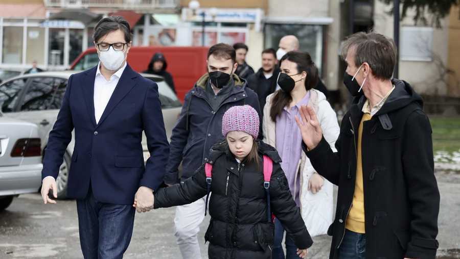 President Stevo Pendarovski held Embla Ademi's hand as he walked her to her school in the city of Gostivar on Monday.