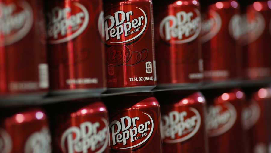 Empty cans of Dr. Pepper soda sit stacked in the warehouse before being filled at the Dr. Pepper Snapple Group Inc. bottling plant in Louisville, Kentucky, U.S., on Tuesday, April 21, 2015.