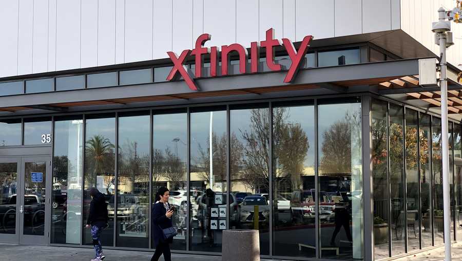 A pedestrian walks by a Comcast Xfinity retail store on January 23, 2020 in San Mateo, California.