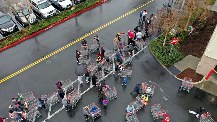 Hundreds of people line up to enter a Costco store on March 14, 2020 in Novato, California.