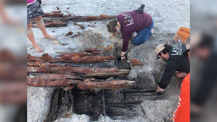 Dorothy Rowland and Nick Budsberg, members of the Lighthouse Archaeological Program, examine the shipwreck on Crescent Beach.