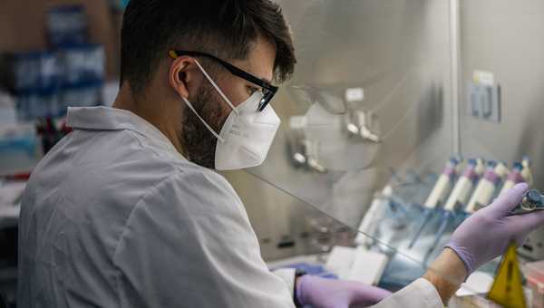 HOUSTON, TEXAS - AUGUST 13: Laboratory Technician David Salazar analyzes COVID-19 samples, during the polymerase chain reaction (PCR) preparation process, at the Genview Diagnosis lab on August 13, 2021 in Houston, Texas.  (Photo by Brandon Bell/Getty Images)